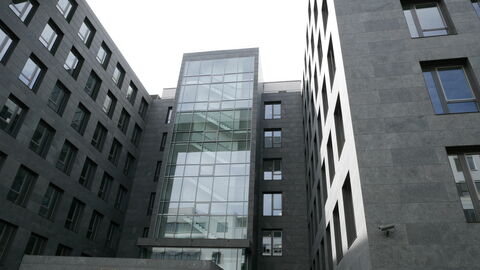 Viele Fenster mit grauer Verkleidung schmücken das Gebäude.